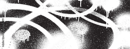 Abstract white graffiti spray paint drips on black background.