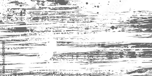 Abstract background with diagonal gray brush strokes and scattered dark particles on a white surface.