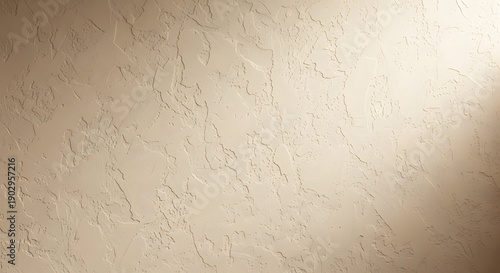 Rough beige plaster wall texture background with directional lig