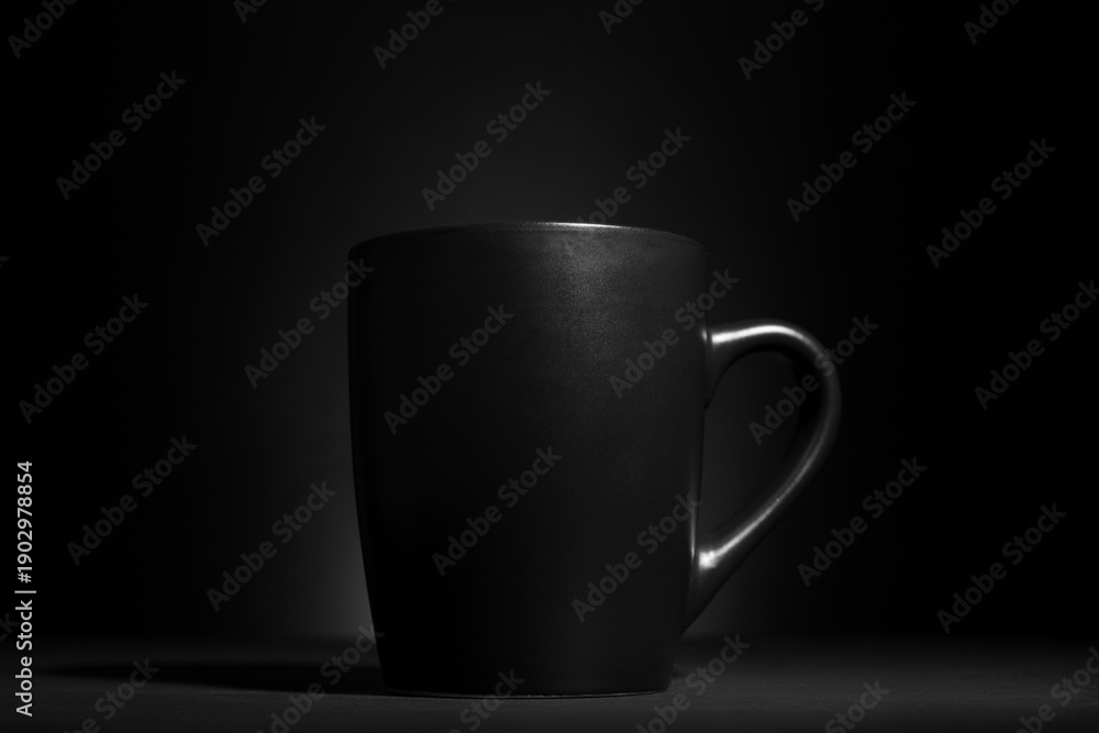 Obraz premium Black cup on dark background, closeup
