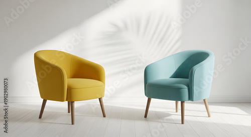 Comfortable and modern living room showcasing two colorful armchairs, naturally lit with graceful leaf shadows against a pristine white wall