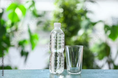Glass and bottle of water o...
