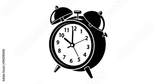 An alarm clock rings loudly on a table indoors.