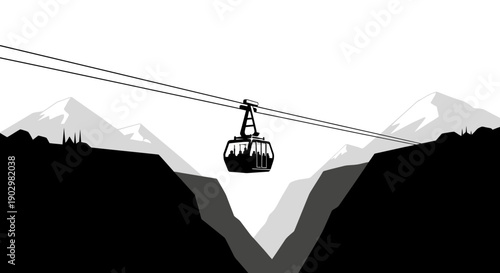 Cable car suspended high above rugged mountains with snowy peaks in the background