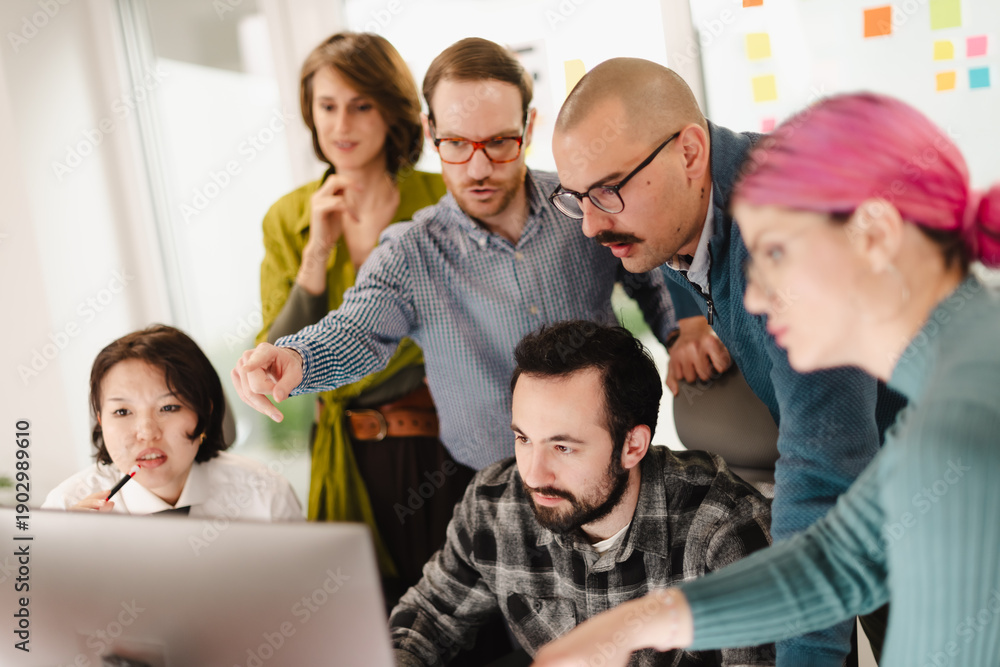 Fototapeta premium Business team collaborates on project in modern office space while analyzing data and brainstorming together