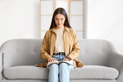 Young woman with Holy Bible...