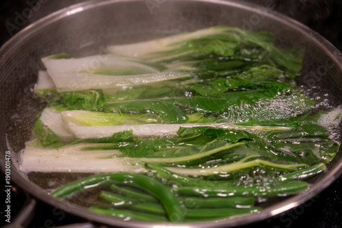 Принти на полотні Bokchoy vegetable is being boiled in water in a pan