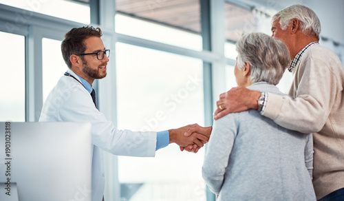Fotografie Handshake, clinic and doctor with senior couple for support, thank you or consulting in office