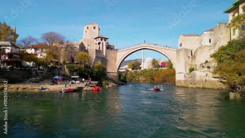 Epic 4K aerial panorama of Mostar Old Town and Stari Most bridge, UNESCO heritage site over turquoise Neretva river, Bosnia and Herzegovina, cinematic cityscape