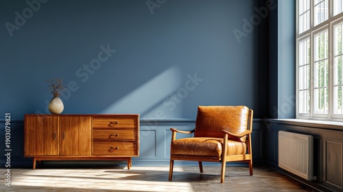 midcentury. Mid-century modern living room featuring a leather armchair and wooden cabinet against a blue wall with natural light. lifestyle magazines.