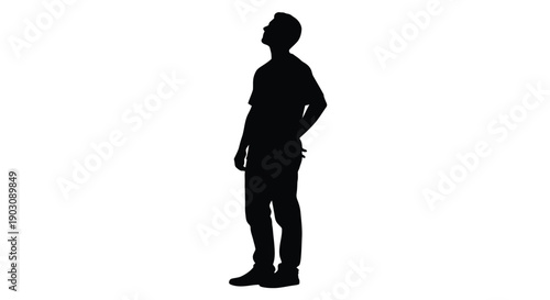 Silhouette of a young man looking upwards with his hand placed casually behind his back