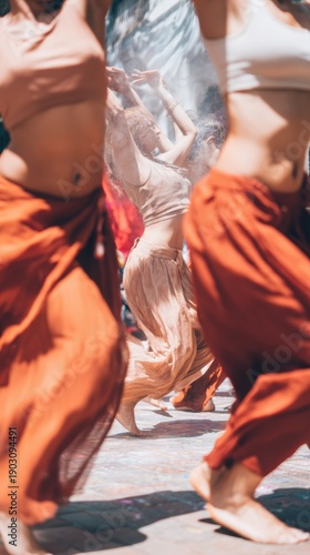 Group of Holi Festival dancers performing rhythmic chgraphy at a spring celebration in a sunny open plaza for travel editorial and cultural event marketing