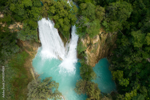 Visit Cascada de Minas Viejas in Huasteca Potosina, a turquoise waterfall surrounded by tropical plants in San Luis Potosi, Mexico