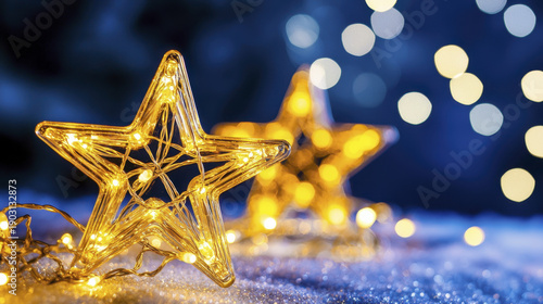 Golden star decorations illuminated with warm lights create magical atmosphere against dark background, evoking joy and wonder