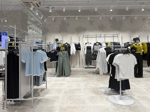 The interior of a casual fashion retail store: basic items on shelves and counters.
