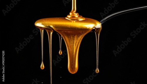 Liquid Gold Stream Flowing Over Spoon in Dark Backdrop for Design Element Rich Texture Shiny and Smooth Background.