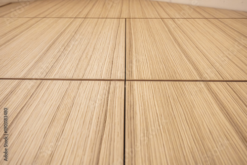 Tableau sur toile Detailed view of aligned light wood cabinet panels with natural vertical grain pattern and minimal seams