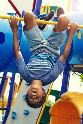 Bild auf Leinwand Boy, upside down and outdoor on playground at monkey bars for swing, holiday and learning balance