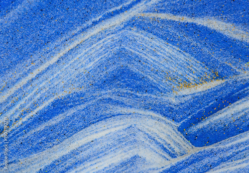 Abstract blue sand waves with golden glitter.