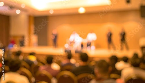 Blurred image of a performance on stage with audience viewing