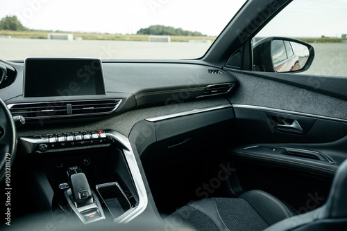 Wallpaper Mural Interior details. Modern black car interior, leather steering wheel, climate control, large navigation system screen. Torontodigital.ca