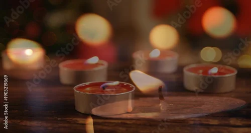 Fototapeta Flickering tealight candle cluster casting warm glow on wood table, with molten wax, bokeh