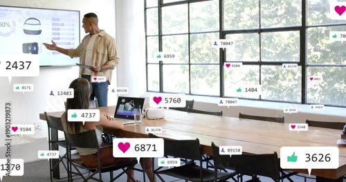 Wallpaper Mural Presenting beige-shirted man pointing at wall screen in meeting-room with social icons, copy space Torontodigital.ca