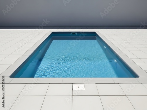 Rectangular swimming pool surrounded by tiled flooring in a minimalist style
