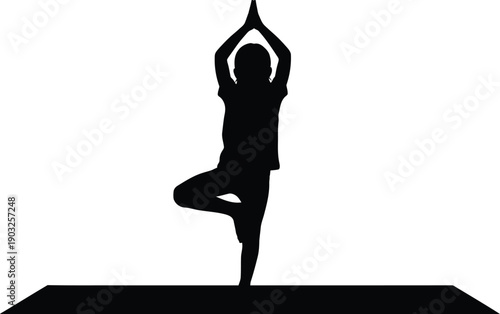 Silhouette of a person in tree pose on a yoga mat in a serene environment with peaceful atmosphere and balance
