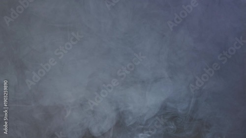 Blue Vapor on Dark Backdrop. Vapor emerging from shadows, forming transient shapes.