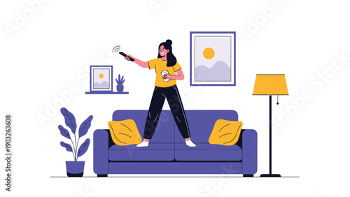 Energetic woman standing on a purple sofa and using a remote control while holding a coffee cup in a living room.