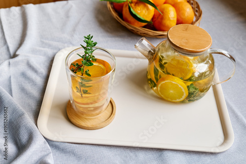 Citrus hot beverage in thermic glass on a table