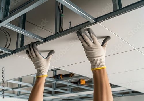 Suspended Ceiling Installation by Technician in Gloves, Construction Site