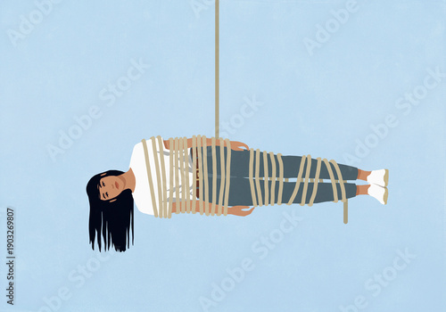 Woman wrapped in rope hanging horizontally on a blue background