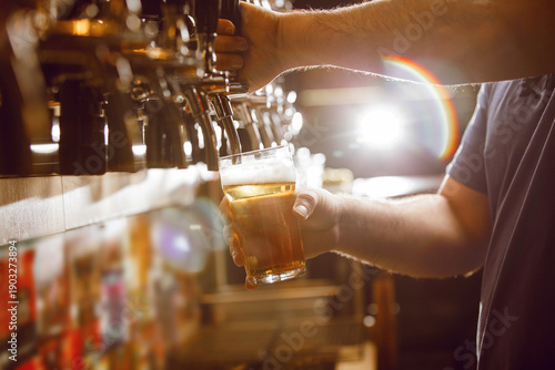 Bartender Pours Fresh Lager Beer From Tap Into Glass in Lively Bar Atmosphere