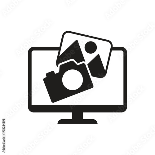 Solid digital photo camera on computer monitor