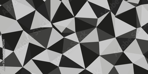 Geometric pattern of abstract shapes in varying shades of gray, creating a mosaic-like effect from a close-up viewpoint