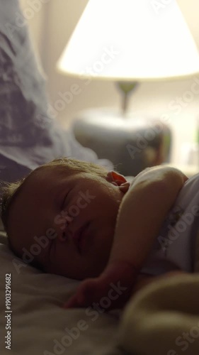 newborn baby sleeping on a bed at night
