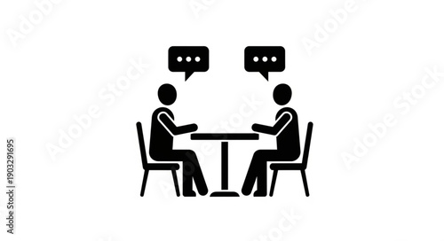 Two people sitting at a table having a conversation.