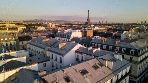 Wallpaper Mural Aerial drone shot over Paris rooftops with Eiffel Tower in background, sunset lighting, cinematic movement, clean architecture. Torontodigital.ca