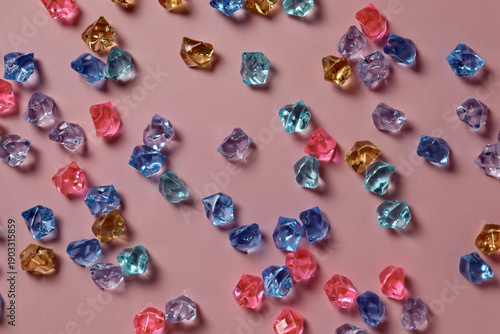 Wallpaper Mural Colorful gems scattered on a pink surface showing different shapes and sizes during daylight hours Torontodigital.ca