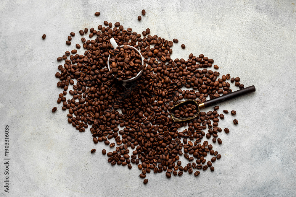 Fototapeta premium Flat lay of coffee beans and a cup on stone background, top view. Making coffee concept