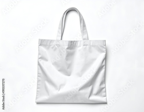 A white, empty tote bag is suspended against a white backdrop, front view