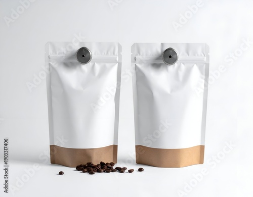 Two pouches with white tops, brown bottoms, and a few coffee beans scattered below