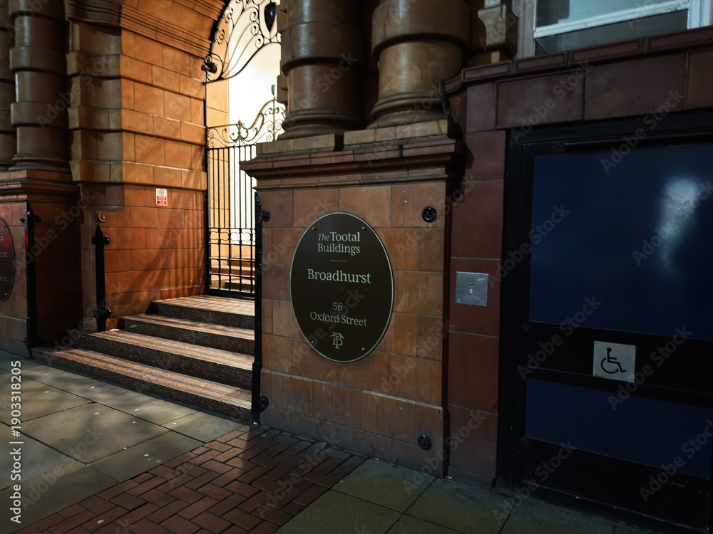 Naklejka premium Historic building entrance on Oxford Street in Manchester with Broadhurst Tootal plaque