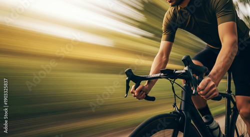 Cyclist riding fast on road with motion blur