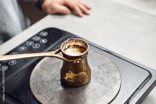 Traditional Turkish Coffee Brewing on Modern Electric Stove, Captured From Above