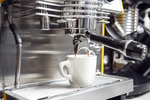 Espresso Machine Pouring Fresh Coffee Into White Cup in Cafe Setting