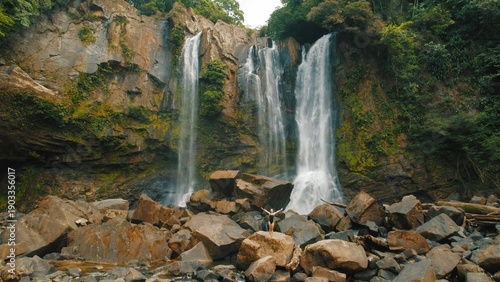 Wallpaper Mural Traveler woman walking on rocks near Nauyaca waterfalls surrounded by jungle in Costa Rica. Torontodigital.ca