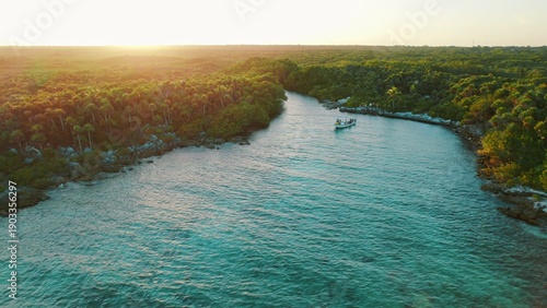 Wallpaper Mural Boat cruising through calm turquoise lagoon at sunset in Yucatan Mexico. Torontodigital.ca